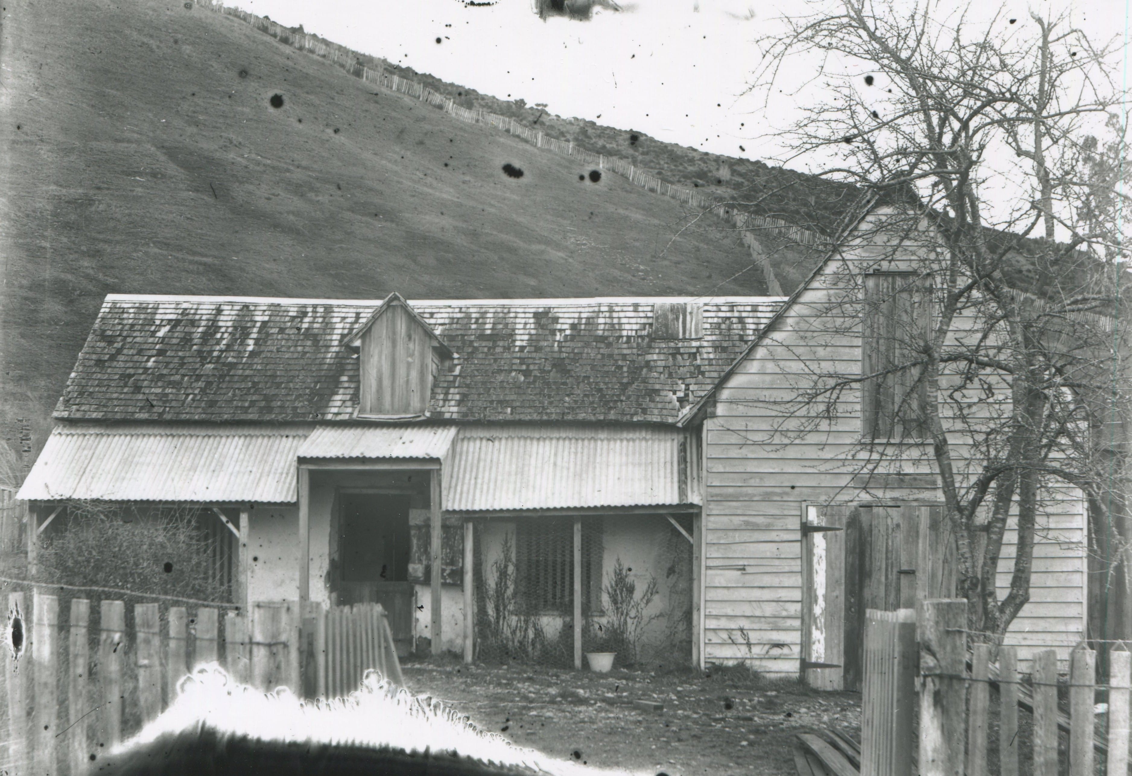 Black and white photo of the original Wakefield School Cob building with additions.