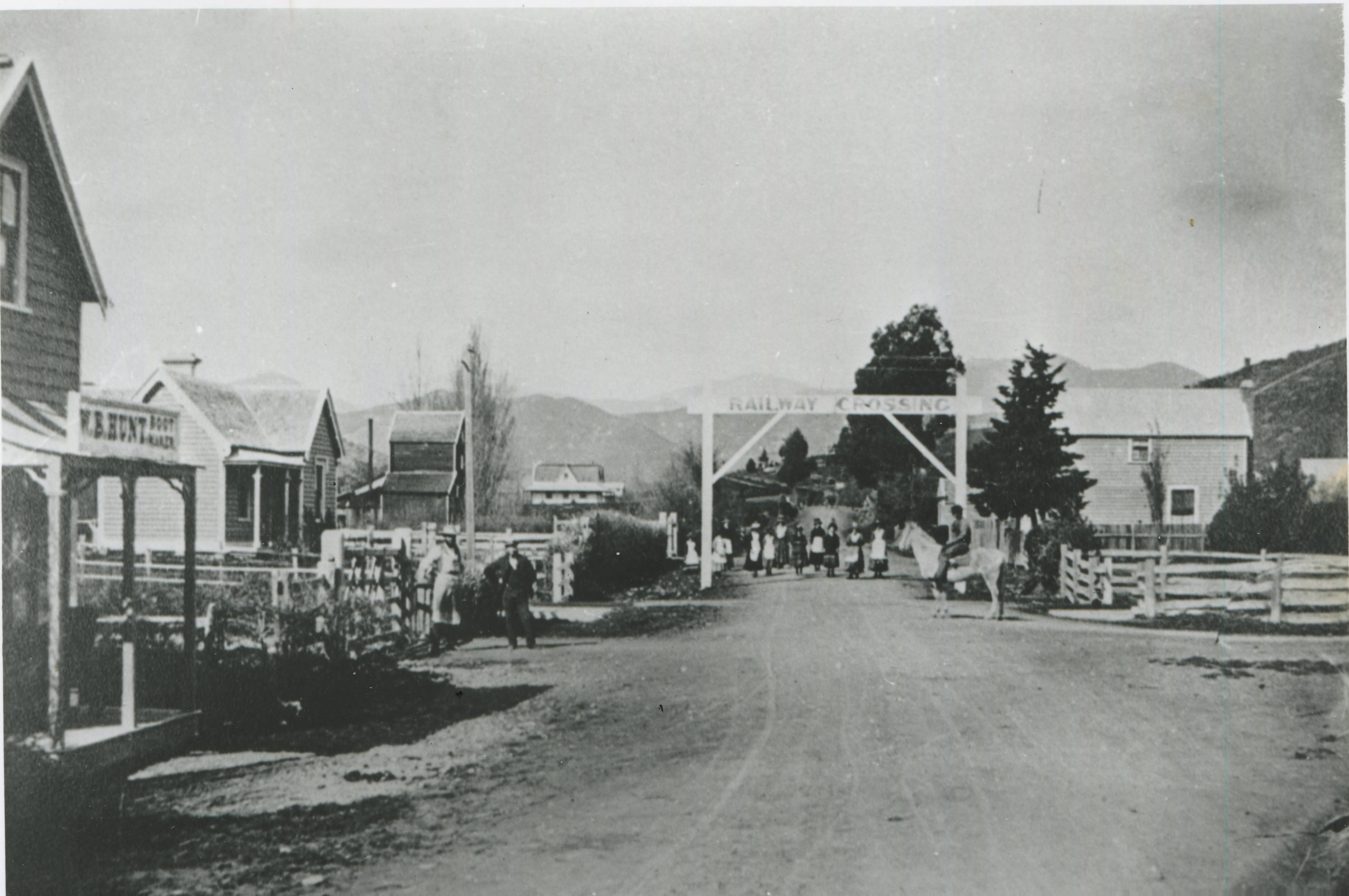 Black and white photo of the view from the Railway Station taken just after the opening, 1876, looking 
                            along a road through town.
