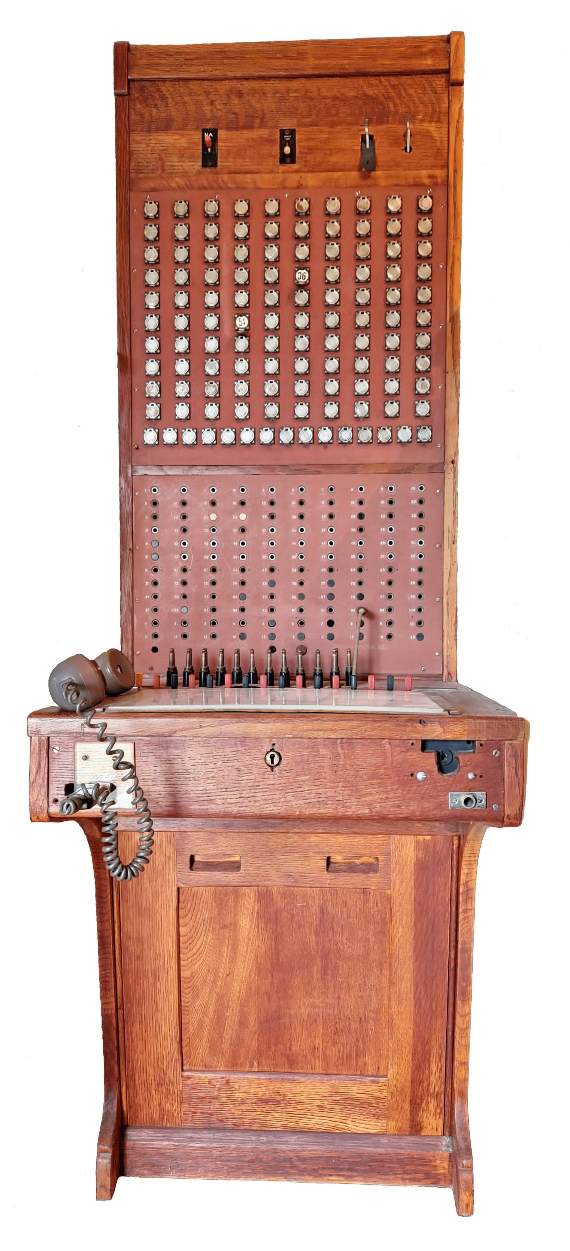 Large standing wooden switchboard with many plugs and wires.