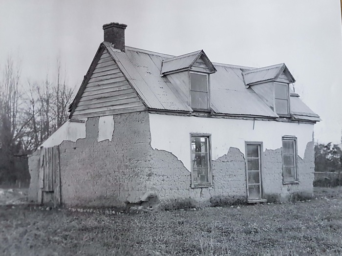 Black and white photo of photo of Photo of William Higgins Cottage in disrepair, 1985.